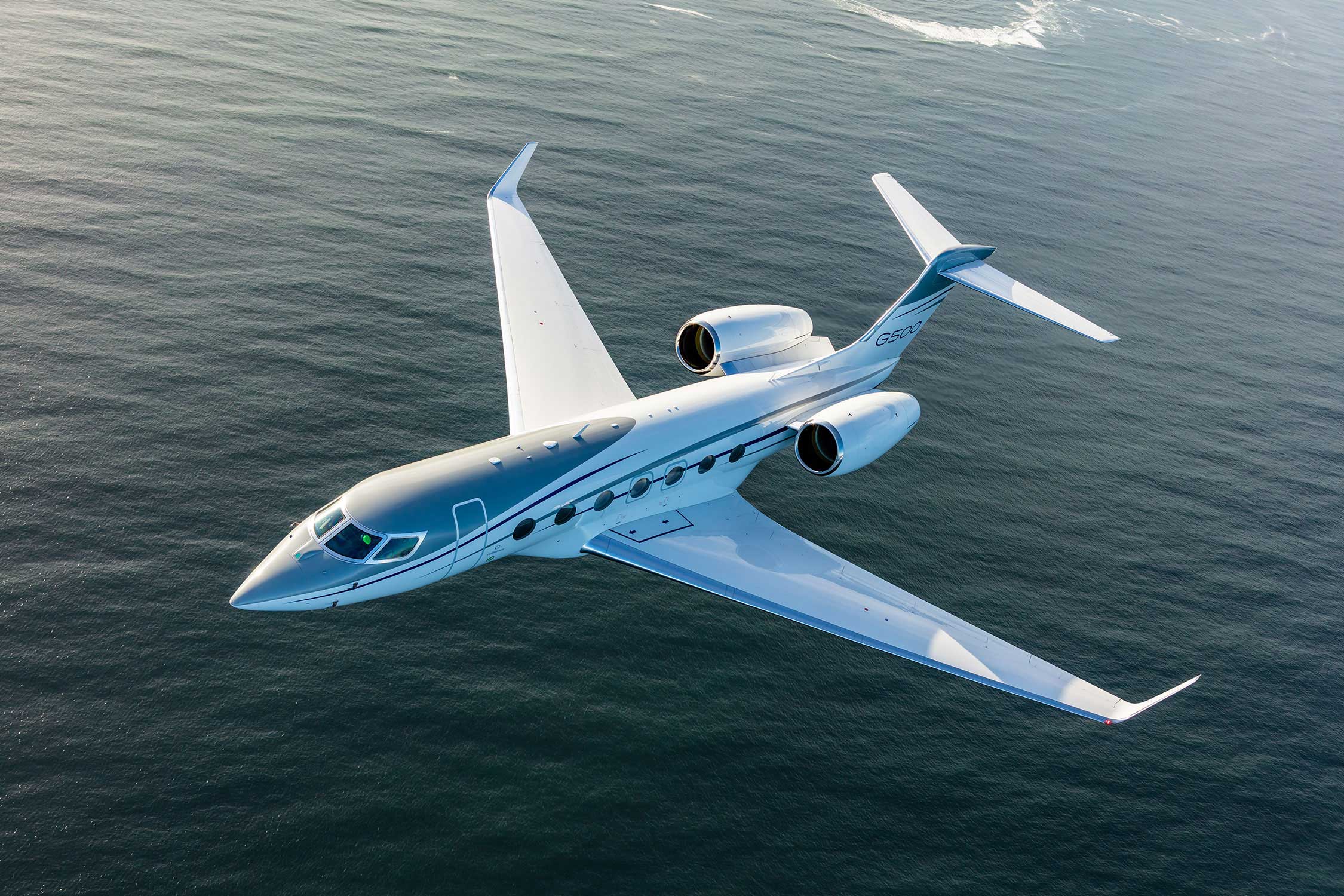 G500 aircraft flying above the ocean