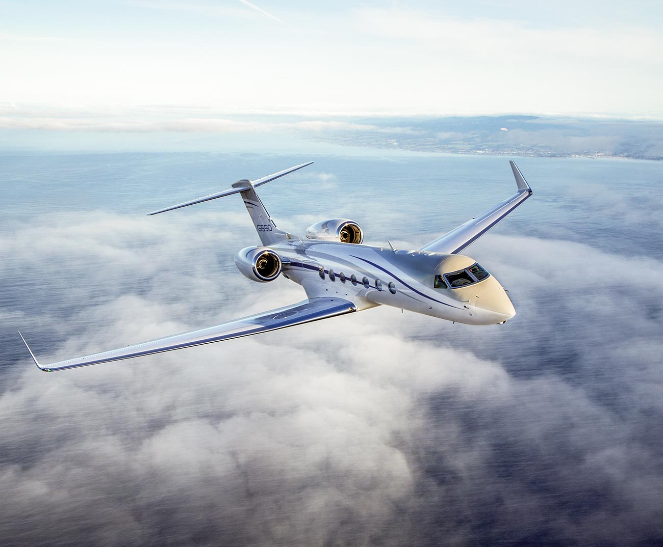 G550 flying over clouds