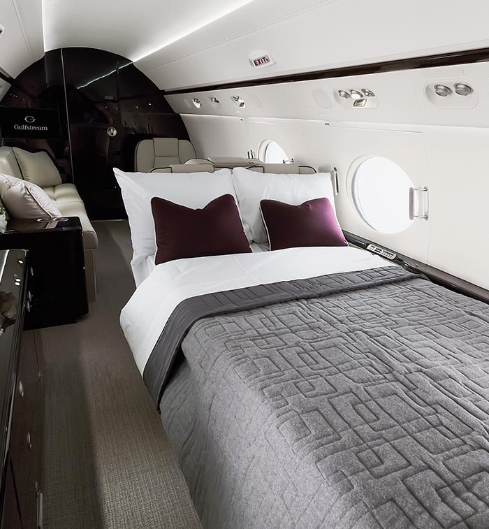 A bed shown inside a private jet cabin