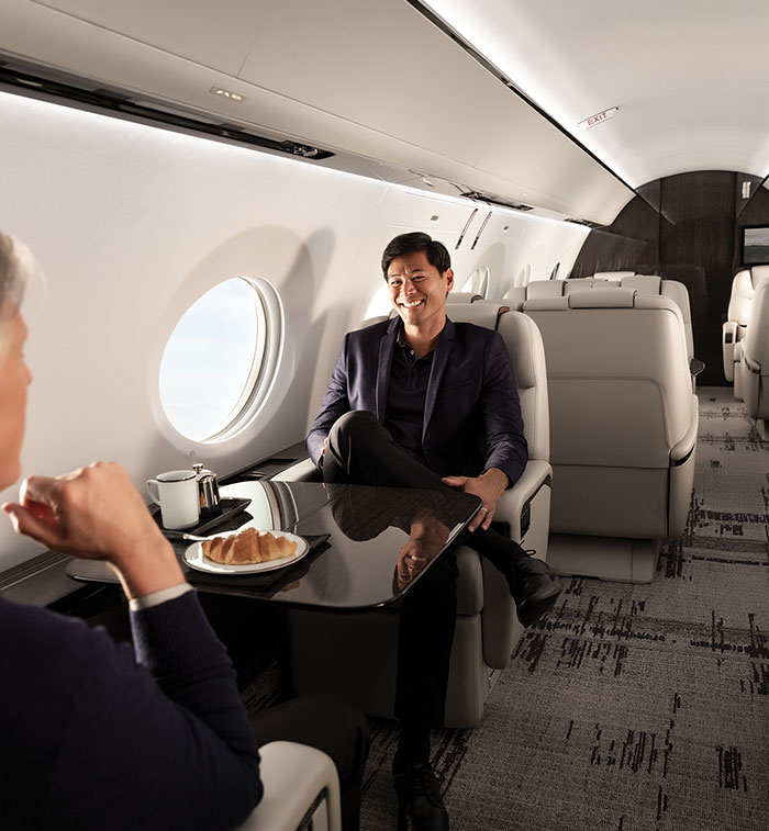 Businessmen seated inside aircraft