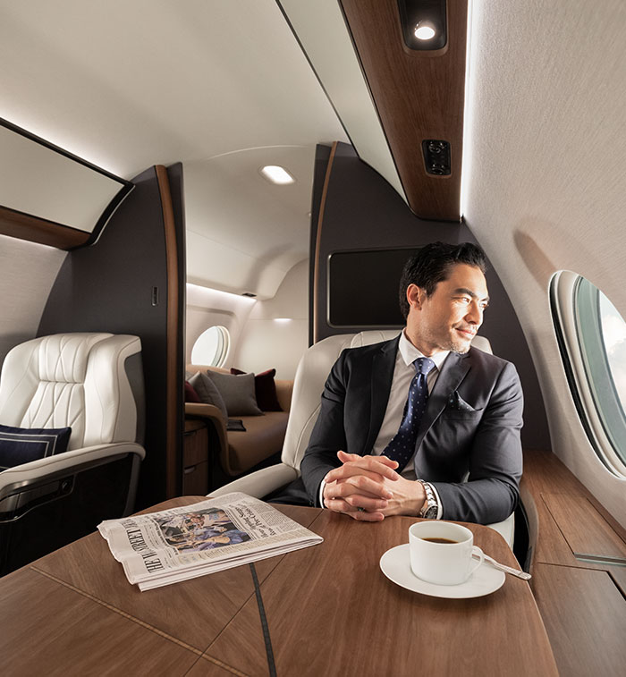 Businessman enjoys view out his private airplane