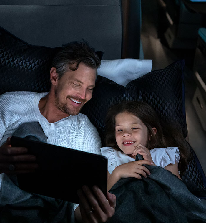 Father and Daughter watching tablet at night