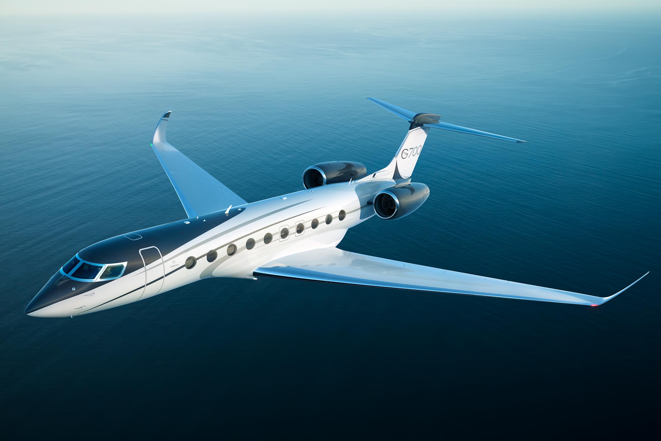 G700 flying over blue water