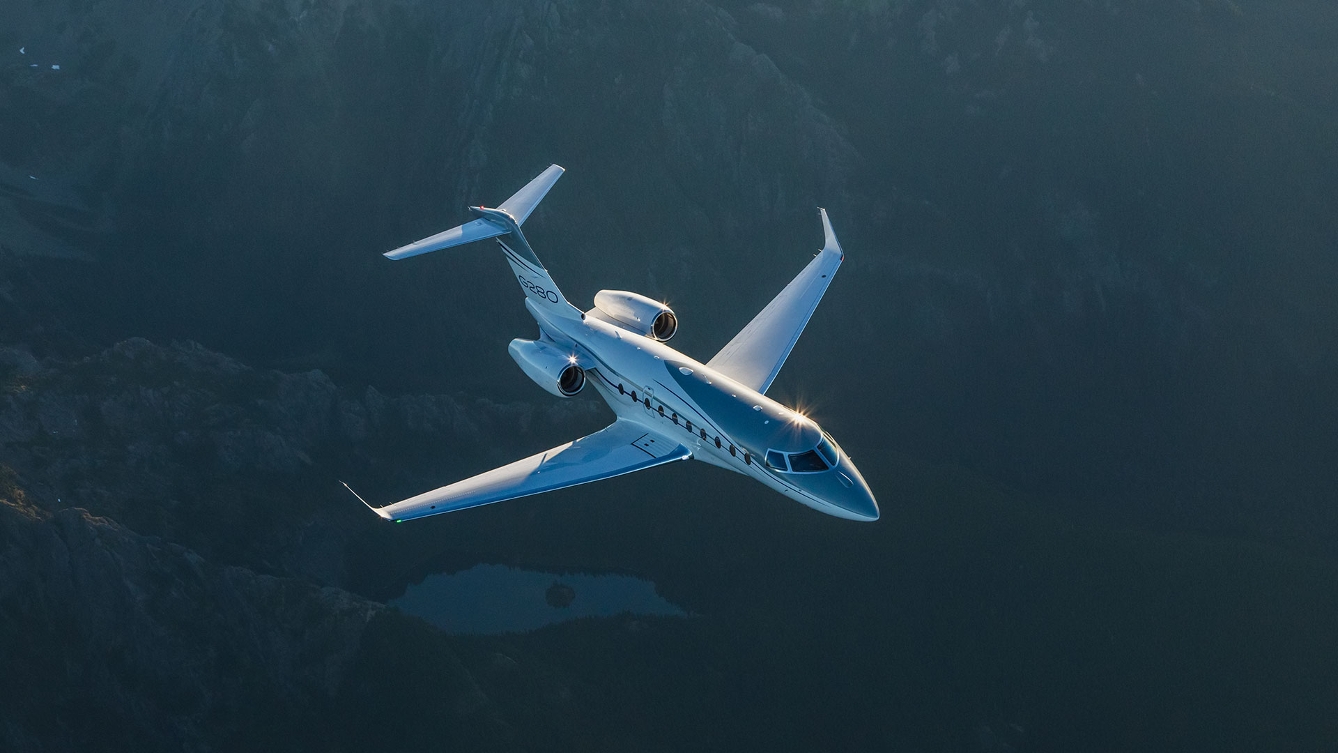 G280 flying over mountains