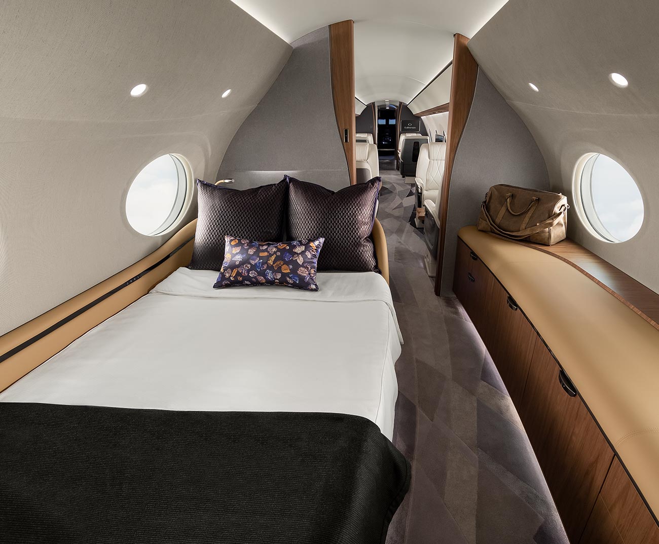 View of bed and dresser in luxury aircraft