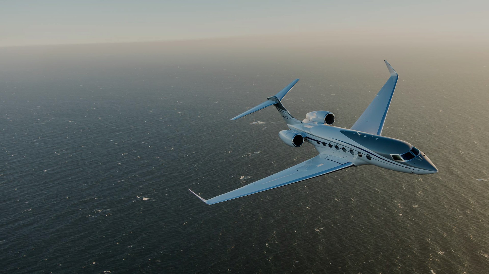 G650ER flying over the ocean towards viewer