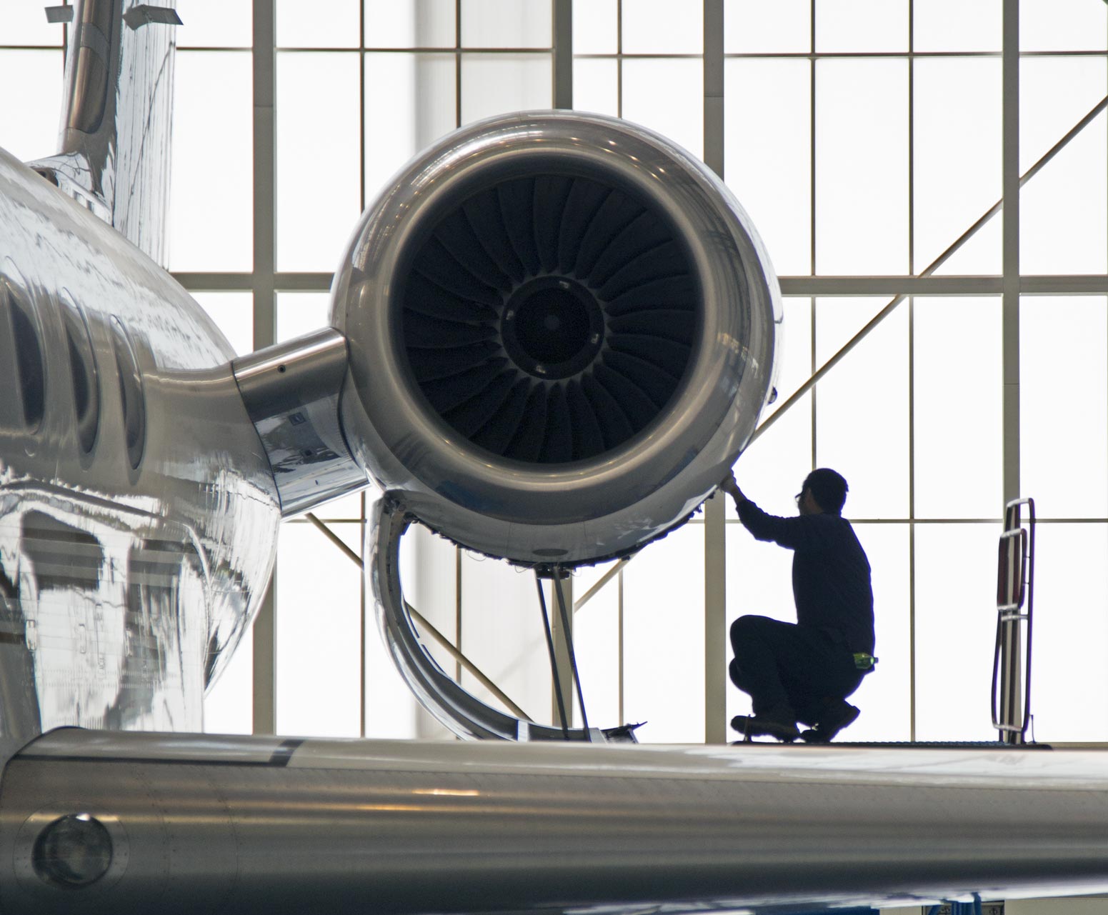 Aircraft technician working on a plane engine